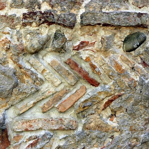 Paramento murario caratterizzato da filari interposti di pietrame, pezzi di mattoni romani sesquipedali ed embrici della stessa epoca